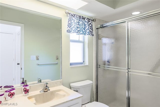 bathroom featuring toilet, walk in shower, and vanity