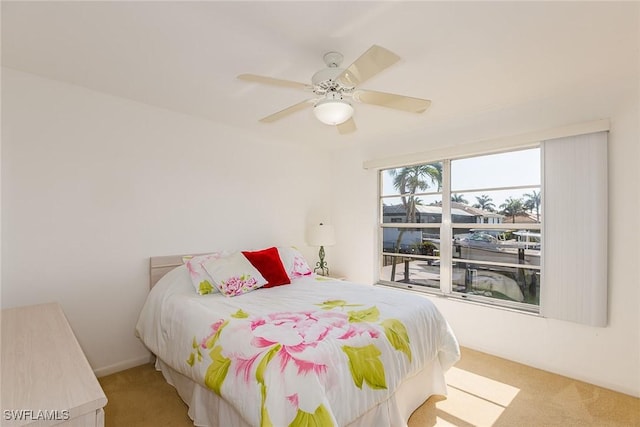 bedroom featuring ceiling fan and light carpet