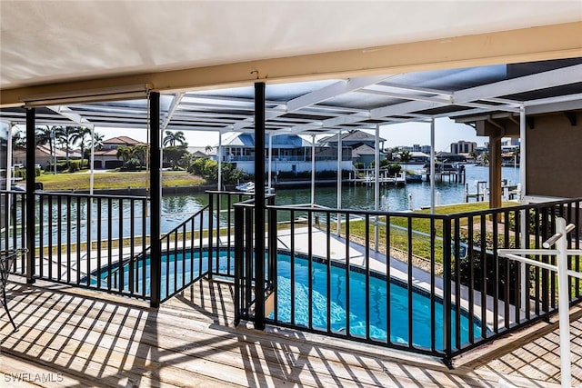 view of swimming pool featuring a lanai, a patio, and a water view