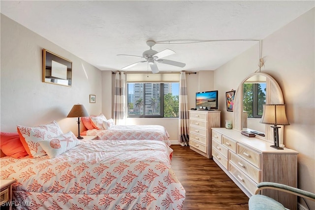 bedroom featuring ceiling fan and dark wood-type flooring