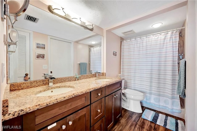 bathroom with hardwood / wood-style floors, vanity, toilet, and a shower with shower curtain