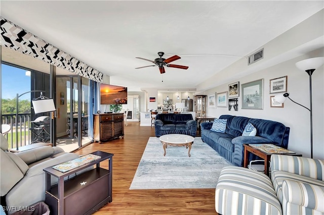 living room with hardwood / wood-style floors and ceiling fan