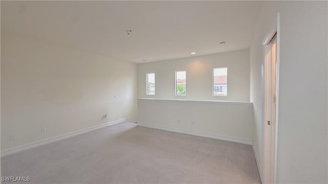 unfurnished room with light colored carpet