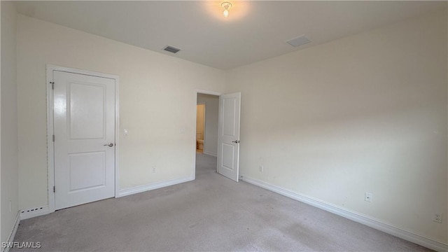 unfurnished bedroom featuring light colored carpet