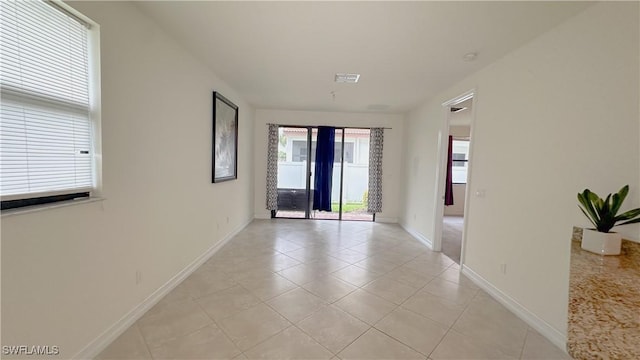 hallway featuring light tile patterned floors