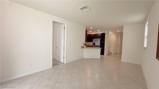 spare room featuring light tile patterned floors