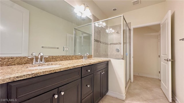 bathroom with tile patterned flooring, an enclosed shower, and vanity