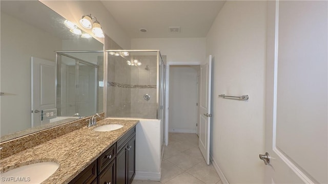 bathroom with vanity, tile patterned floors, and a shower with door