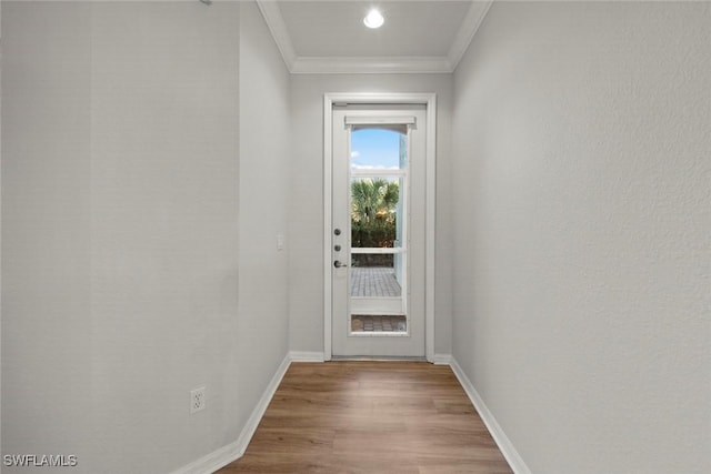 doorway with wood-type flooring and ornamental molding