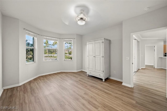 unfurnished bedroom featuring ceiling fan and light wood-type flooring