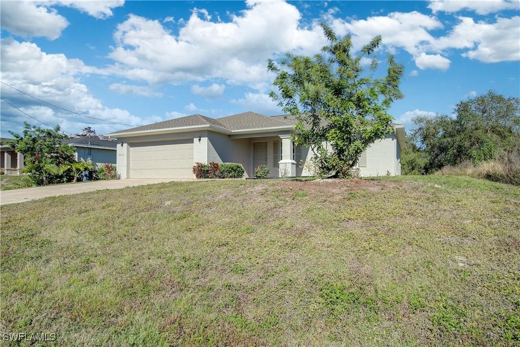 view of front of house with a garage and a front yard