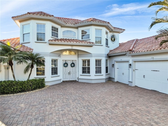 mediterranean / spanish-style home featuring a garage