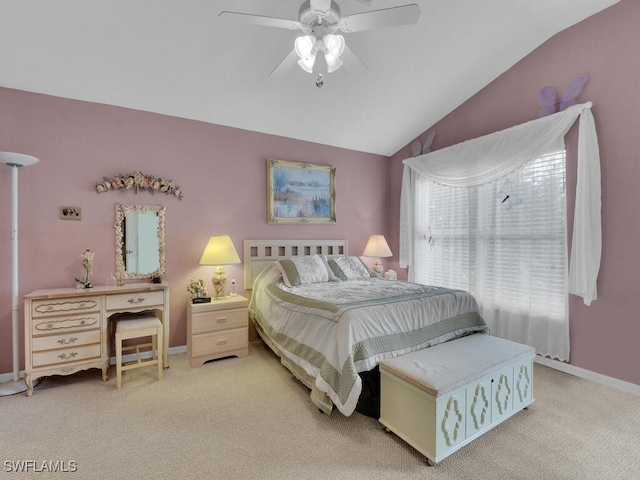 bedroom featuring baseboards, lofted ceiling, carpet flooring, and a ceiling fan