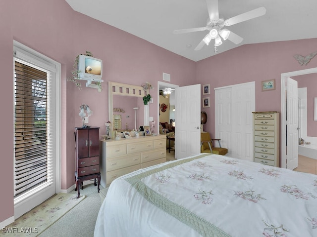 bedroom featuring light colored carpet, vaulted ceiling, visible vents, a ceiling fan, and ensuite bathroom