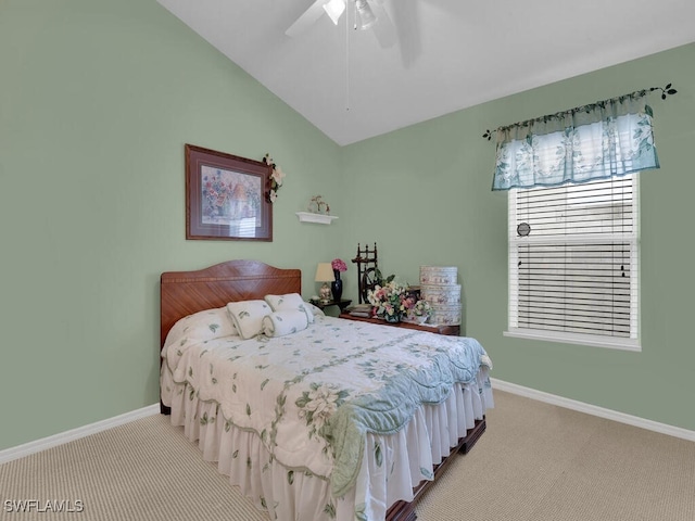 carpeted bedroom featuring baseboards, lofted ceiling, and a ceiling fan