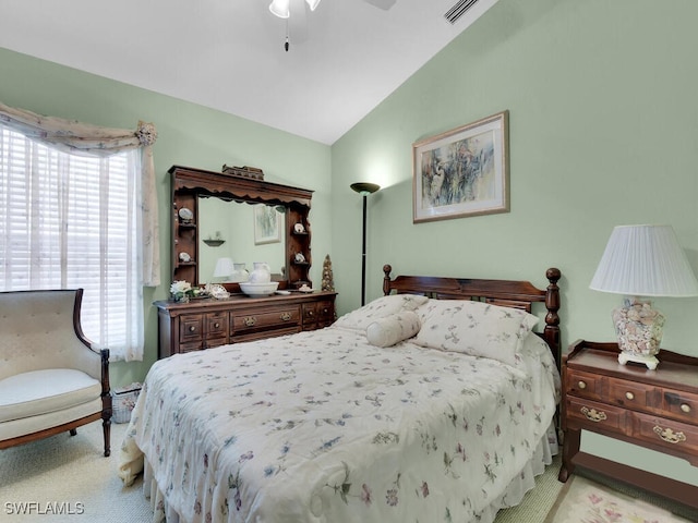 carpeted bedroom with ceiling fan and vaulted ceiling