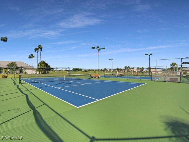 view of tennis court with fence