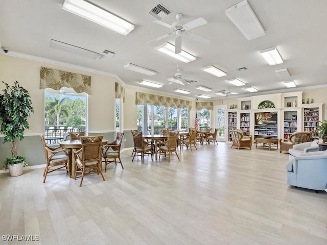 dining room featuring crown molding, light hardwood / wood-style flooring, and ceiling fan