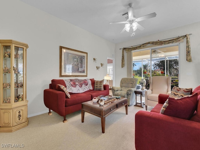 carpeted living room with ceiling fan