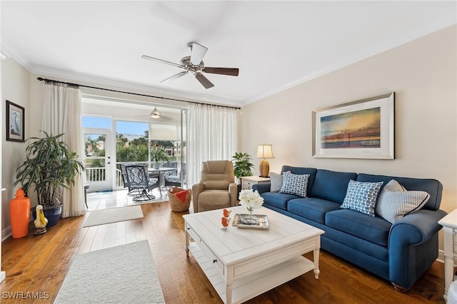 living room with ornamental molding, ceiling fan, and dark hardwood / wood-style flooring