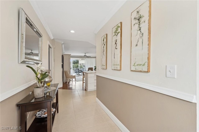 corridor featuring ornamental molding and light tile patterned floors