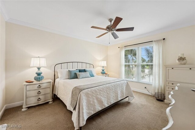 carpeted bedroom with ceiling fan and crown molding