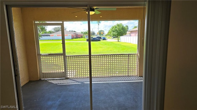 doorway with ceiling fan and a healthy amount of sunlight