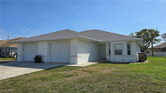 view of front of house with a garage and a front yard