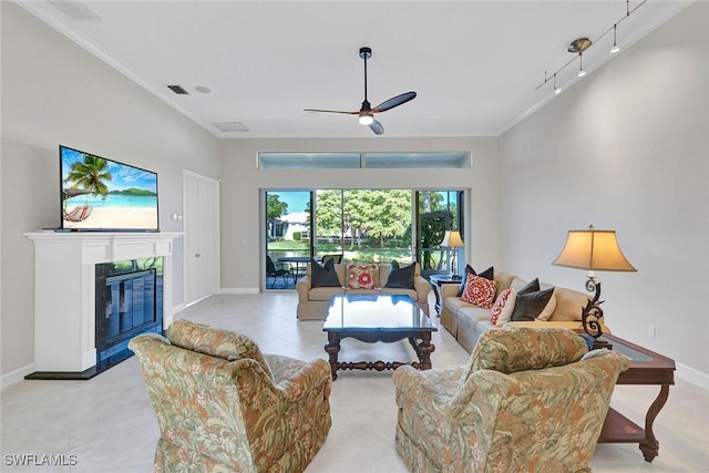 living room featuring ceiling fan, track lighting, ornamental molding, and a fireplace