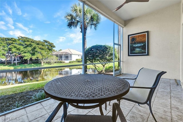 view of patio / terrace with ceiling fan and a water view