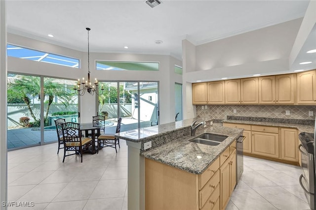 kitchen featuring pendant lighting, an inviting chandelier, backsplash, stainless steel electric range oven, and sink