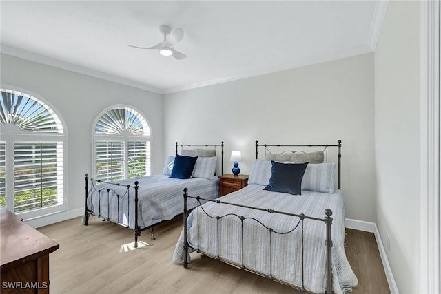 bedroom featuring ceiling fan, ornamental molding, and light hardwood / wood-style flooring