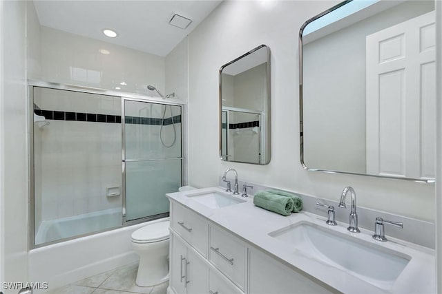 full bathroom featuring toilet, combined bath / shower with glass door, tile patterned flooring, and vanity