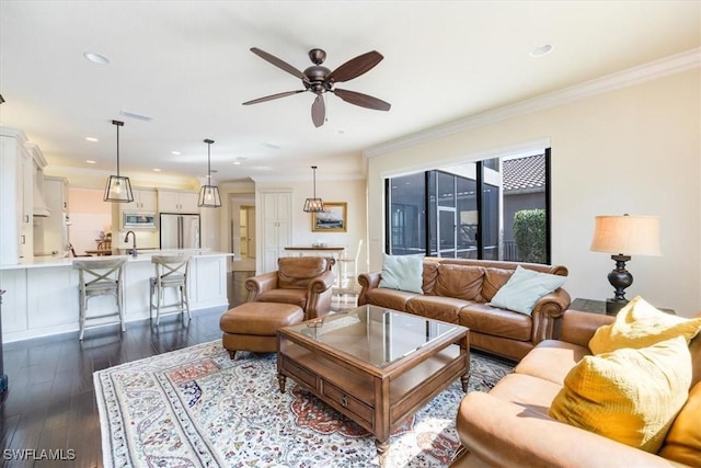 living room featuring ceiling fan, ornamental molding, and dark hardwood / wood-style flooring