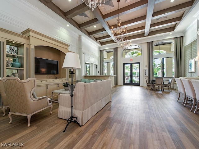 living room featuring french doors, hardwood / wood-style floors, beamed ceiling, an inviting chandelier, and coffered ceiling