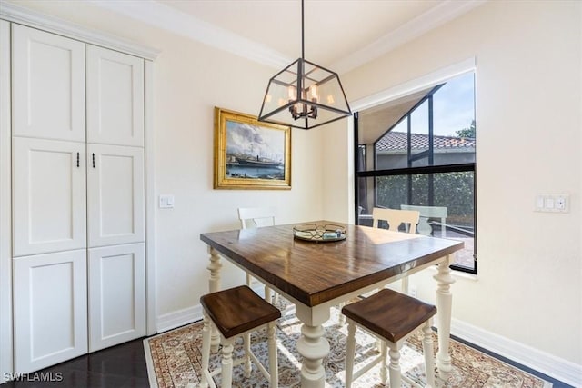 dining space featuring a notable chandelier, ornamental molding, and dark hardwood / wood-style floors