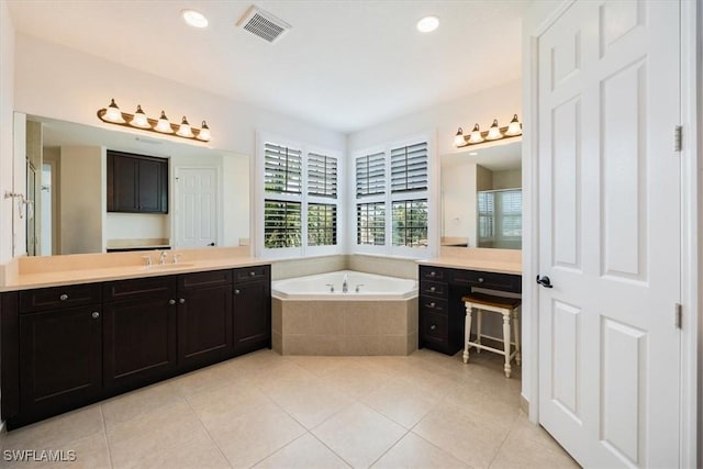 bathroom with tile patterned flooring, separate shower and tub, and vanity