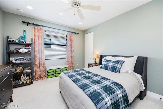 bedroom with ceiling fan and light carpet