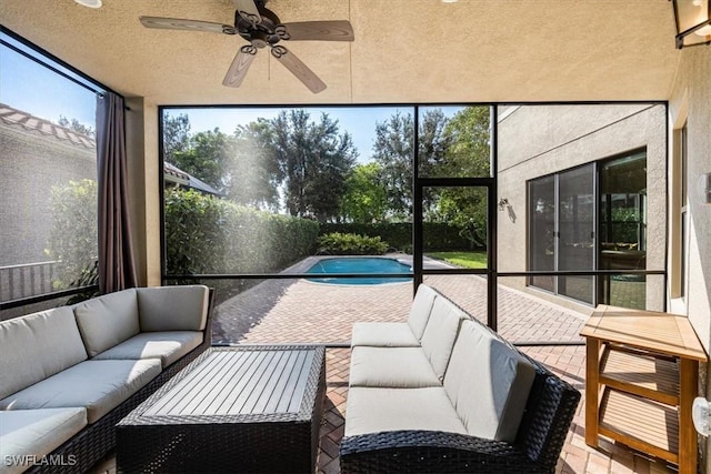 sunroom / solarium featuring ceiling fan