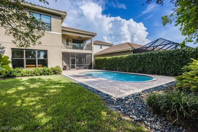 view of swimming pool featuring a yard and a patio