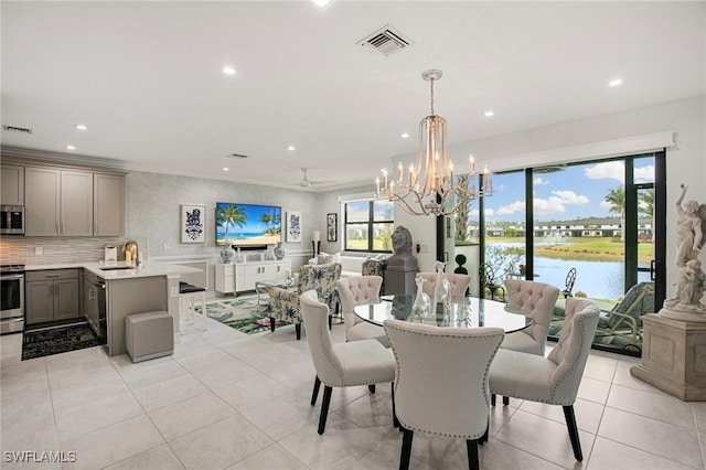 dining area featuring sink, an inviting chandelier, and light tile patterned floors