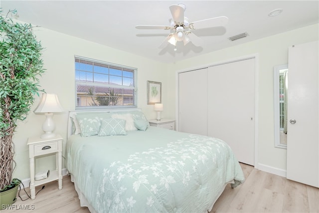 bedroom featuring ceiling fan, a closet, and light hardwood / wood-style floors