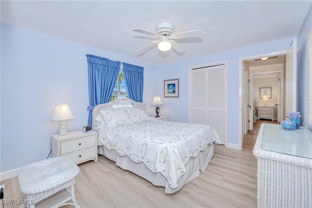 bedroom with ceiling fan, a closet, and light hardwood / wood-style flooring