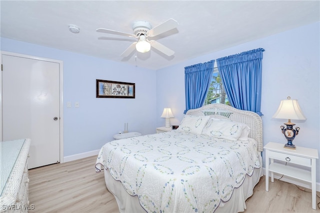 bedroom with ceiling fan and light hardwood / wood-style flooring