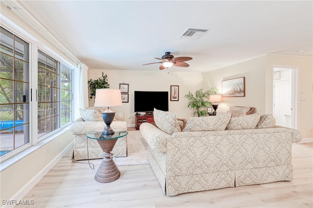 living room with ceiling fan and light hardwood / wood-style flooring