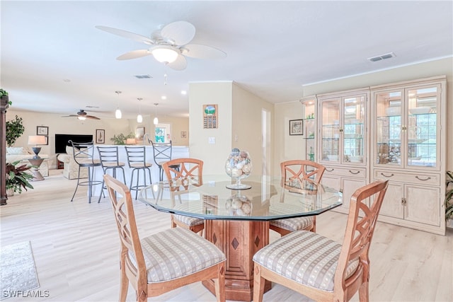 dining area featuring ceiling fan and light hardwood / wood-style flooring