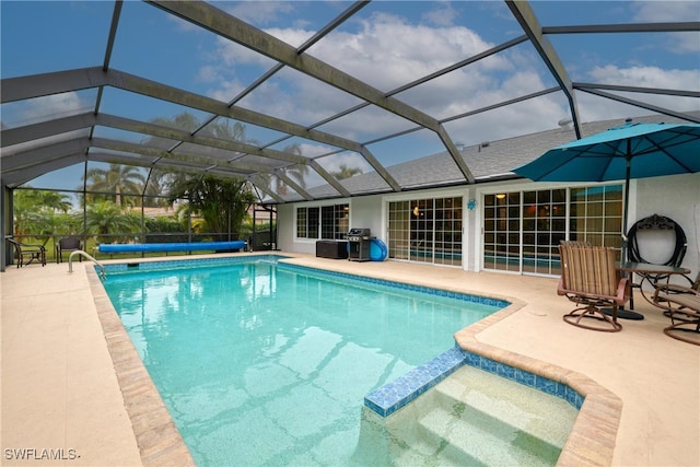 view of pool with a lanai, a patio area, and grilling area