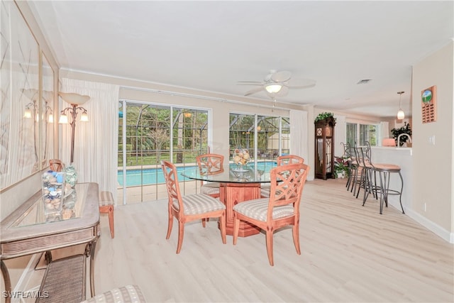 dining room with ceiling fan and light hardwood / wood-style flooring