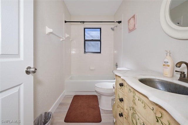 full bathroom with toilet, tiled shower / bath, hardwood / wood-style floors, and vanity