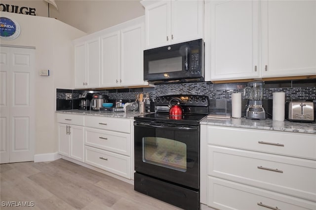 kitchen with light wood-type flooring, white cabinets, tasteful backsplash, and black appliances